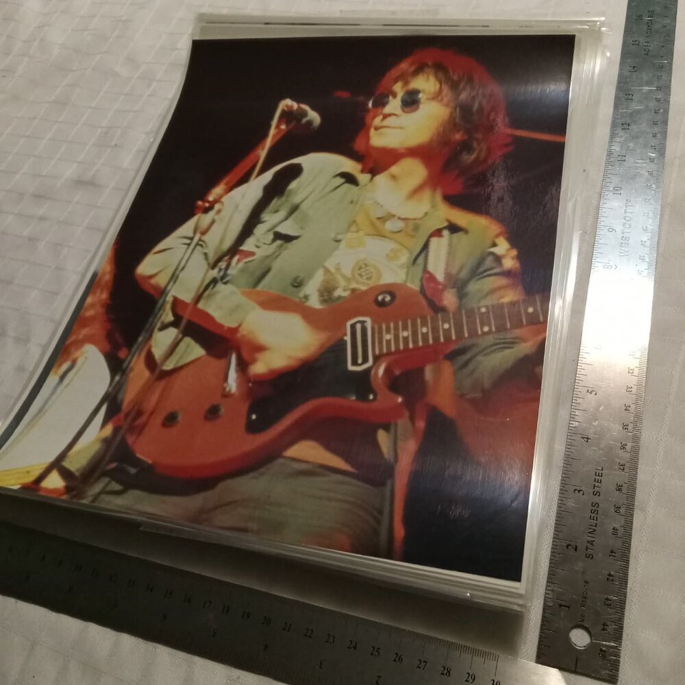 No5 : Eleven (11) laminated in plastic posters featuring John Lennon